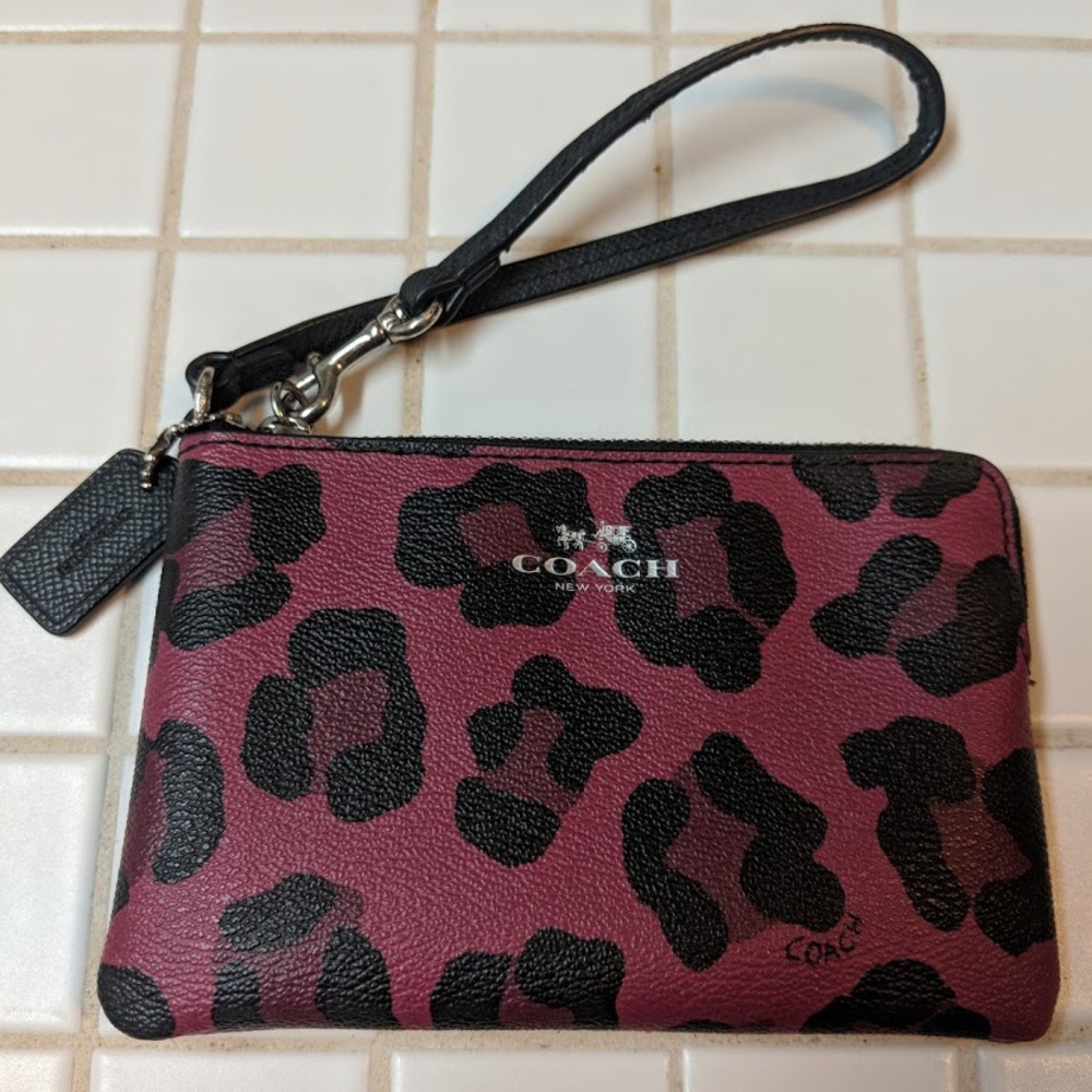 Magenta leopard print Coach wristlet.